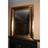 A GILT WALL MIRROR, with molded frame, 1