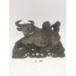 A LATE 19TH CENTURY CHINESE CARVED HARDWOOD MODEL OF A WATER BUFFALO with two figures on his back,