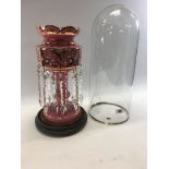 A VICTORIAN PINK GLASS LUSTRE with foliate enamel and gilded decoration hung with a double row of