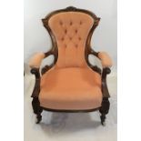A GOOD VICTORIAN ROSEWOOD ARMCHAIR, the foliate carved frame with buttoned upholstery,