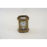 AN EARLY 20TH CENTURY OVAL BRASS 8 DAY CARRIAGE CLOCK,