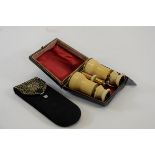 A PAIR OF LATE 19TH CENTURY IVORY VENEERED OPERA GLASSES (faults) with leather storage case,