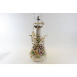 A 19TH CENTURY PORCELAIN VASE with floral encrusted decoration and eagle form side handles,