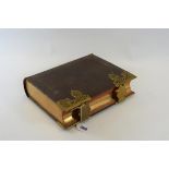 AN 1880 LEATHER BOUND HOLY BIBLE illustrated with steel engravings, with foliate gilt metal clasps,