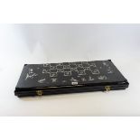 A LARGE 20TH CENTURY BLACK LACQUER AND MOTHER-OF-PEARL INLAID FOLDING CHESS BOARD with figure and
