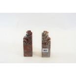 A PAIR OF LATE 19TH CENTURY CHINESE CARVED SOAPSTONE BOOKENDS each adorned with seated figures,