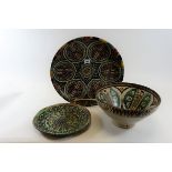 AN EARLY 20TH CENTURY MOORISH INFLUENCE GLAZED POTTERY SHALLOW DISH decorated with stylised floral