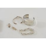 AN ABSTRACT SILVER BRACELET, a pair of matching EARRINGS and two silver BANGLES,