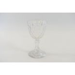 A LARGE VICTORIAN GLASS GOBLET with thumb cut bowl raised on a hollow baluster stem with circular