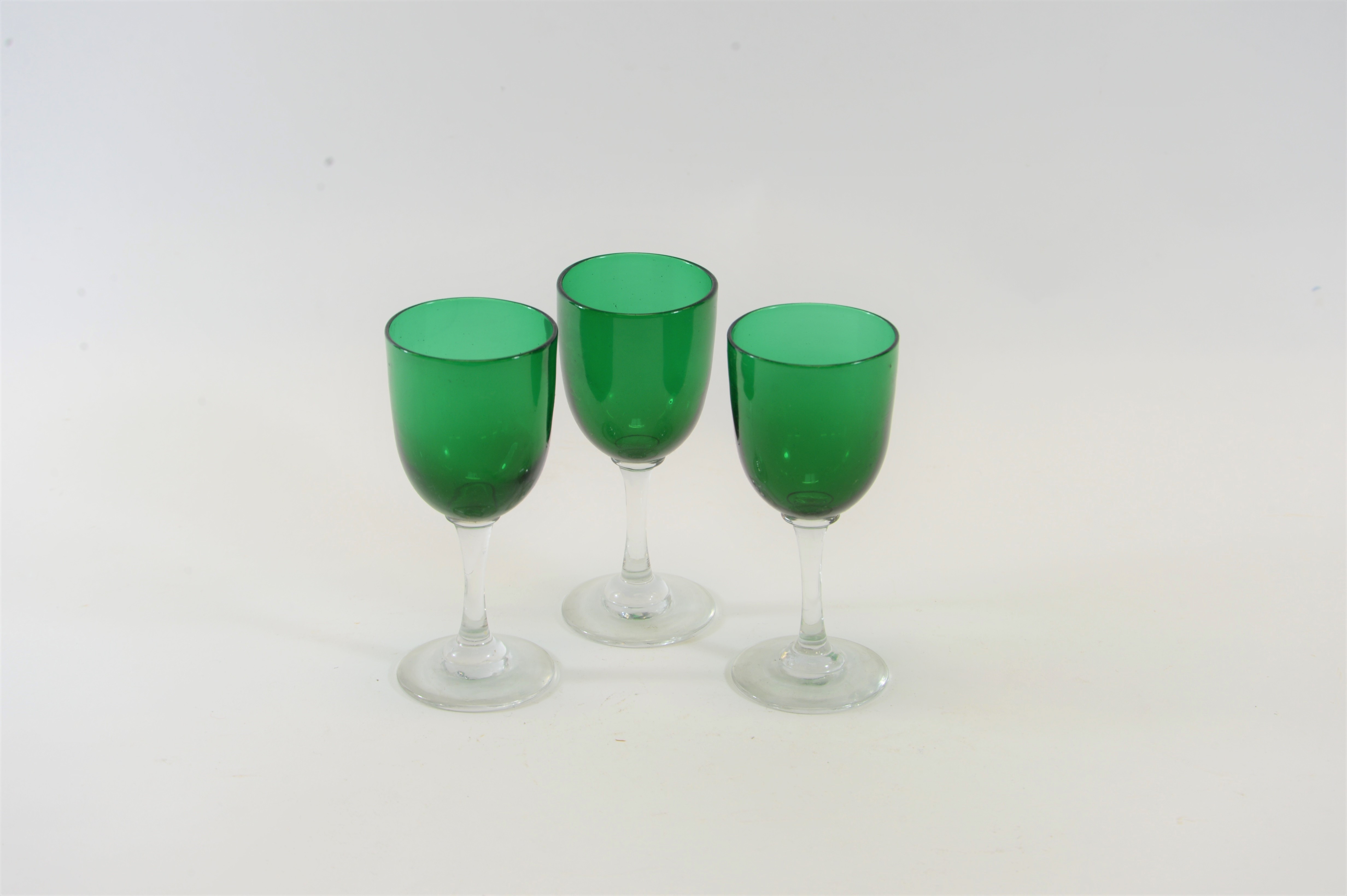 THIRTEEN LATE 19TH CENTURY GREEN BOWL WINE GLASSES with clear stems and circular foot-rings each 5