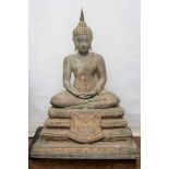 AN IMPRESSIVE ORIENTAL BRONZE BUDDHA seated on a four tier base with cast foliate decoration and