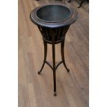 AN EDWARDIAN STAINED BEECHWOOD CIRCULAR JARDINIERE with railed sides and chains, on outswept legs,