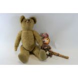 A 20TH CENTURY GOLDEN PLUSH TEDDY BEAR with jointed limbs, stitched nose and glass eyes,