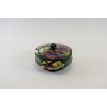 A 20TH CENTURY MOORCROFT POTTERY GREEN/BLUE GLAZED SHALLOW BOWL AND COVER decorated in the hibiscus