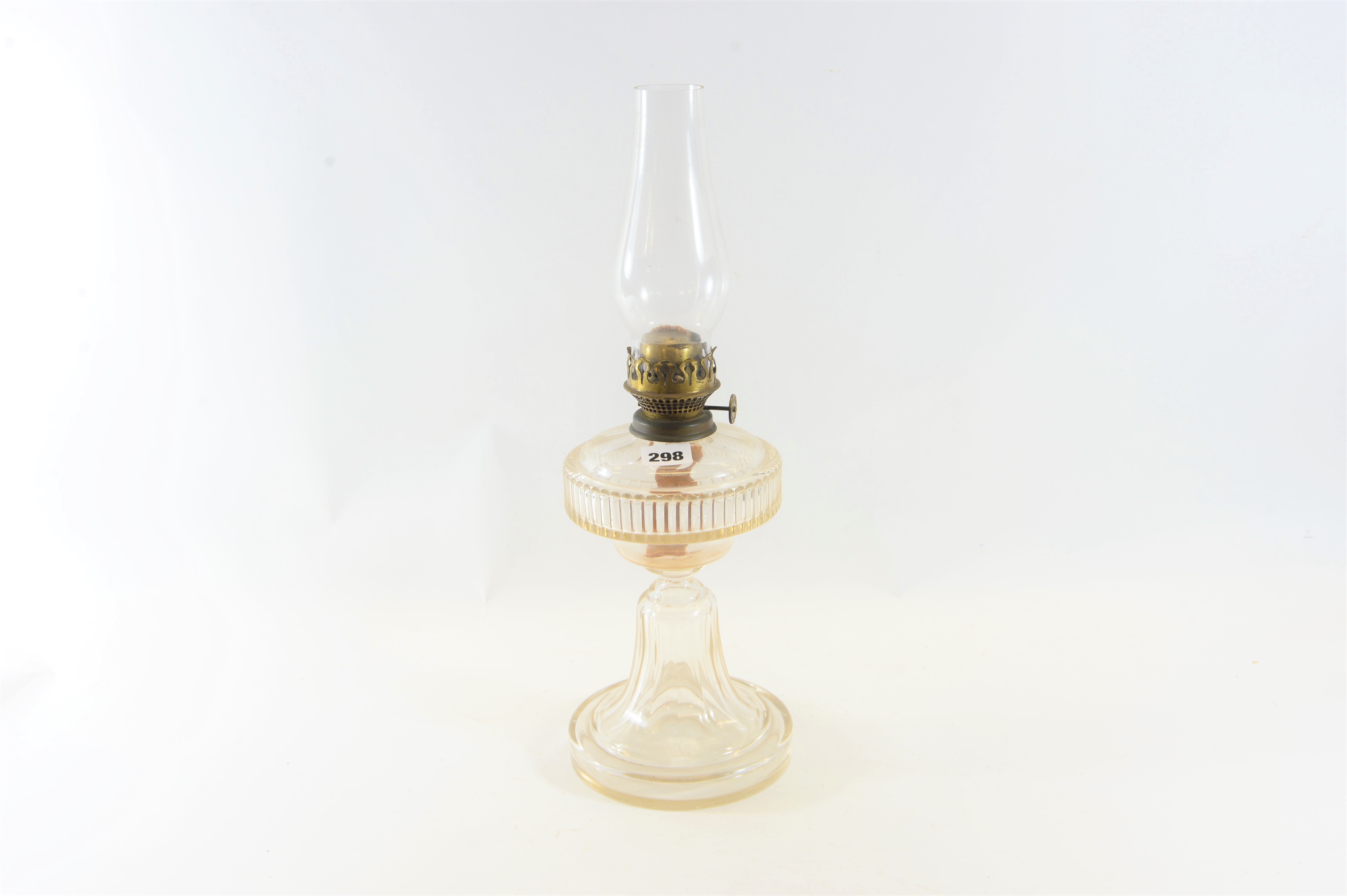 A LATE 19TH CENTURY CLEAR CUT GLASS TABLE OIL LAMP with integral circular base,