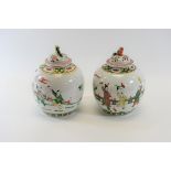 A PAIR OF REPUBLICAN PERIOD CHINESE PORCELAIN OVOID JARS AND COVERS decorated with figures at play