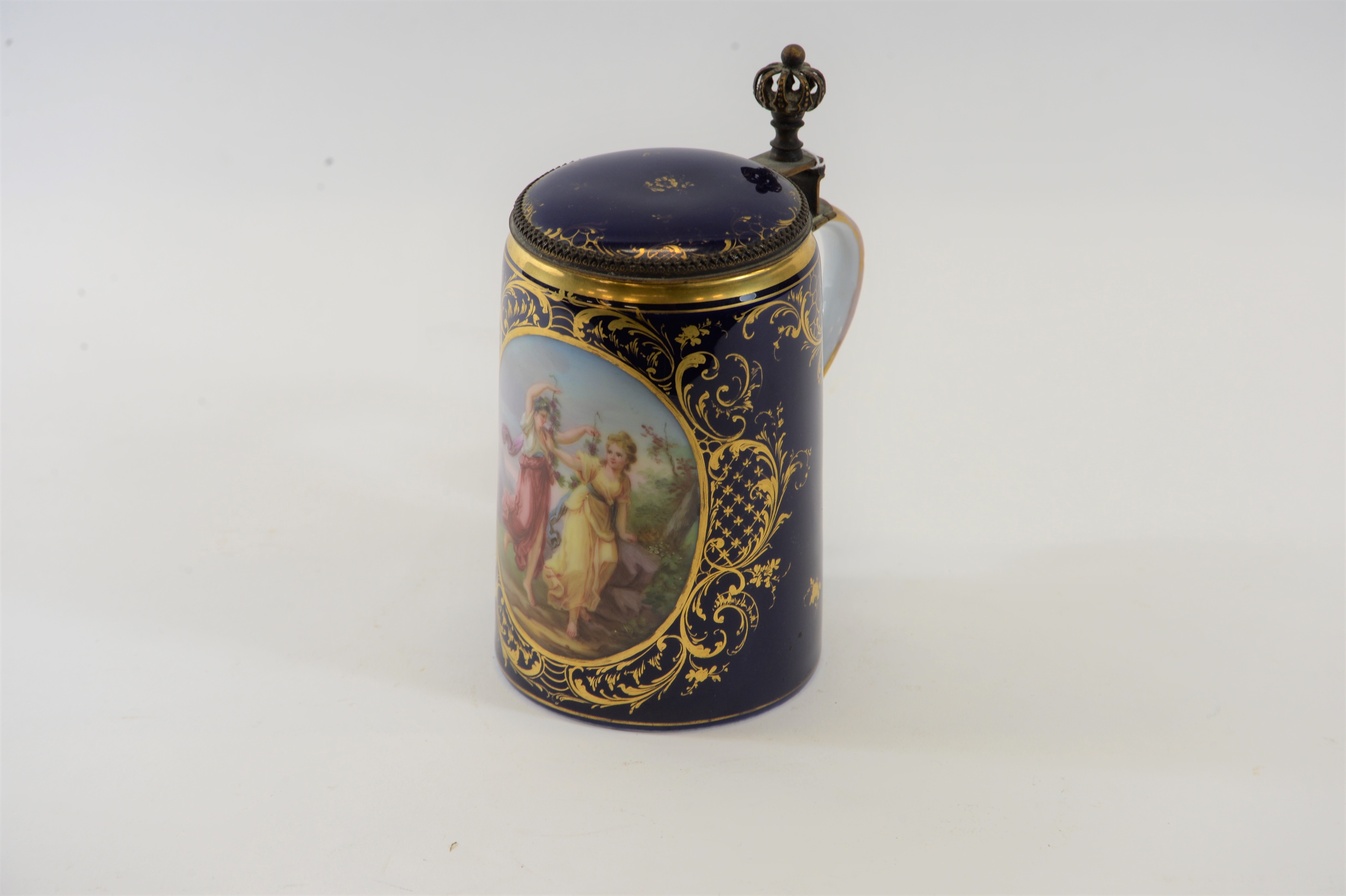A 19TH CENTURY VIENNA PORCELAIN BLUE GROUND LIDDED TANKARD with hand painted panel of romantic