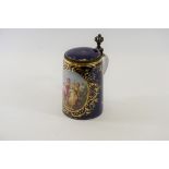 A 19TH CENTURY VIENNA PORCELAIN BLUE GROUND LIDDED TANKARD with hand painted panel of romantic