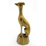 A mid - late 20thC cast brass sculpture of a seated Long dog / greyhound.