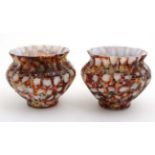 A pair of small glass pots,