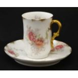A CH Field Haviland Limoges GDM cup and GCM saucer in pink roses pattern with gilt highlights on a