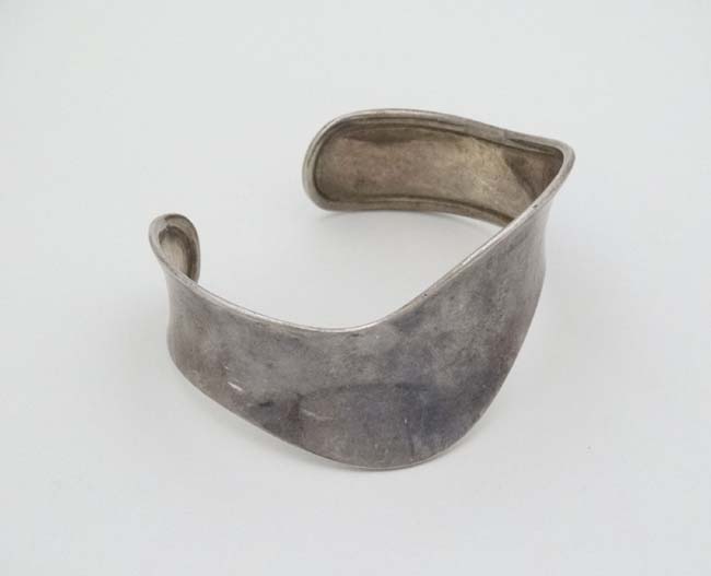 A silver bracelet of bangle form CONDITION: Please Note - we do not make reference