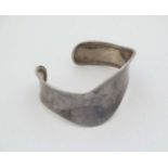 A silver bracelet of bangle form CONDITION: Please Note - we do not make reference