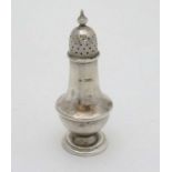 A silver pepperette of baluster form with screw top.