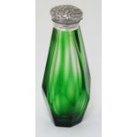 A green glass scent bottle with white metal top.