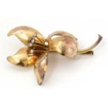 A Swiss Gilt metal brooch of floral form, set with white stones and marked SWISS MADE.