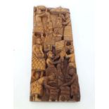 An ethnographic native tribal carved hardwood relief depicting a royal figure with attendants 15