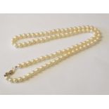 A pearl necklace with 9ct gold bow formed clasp.