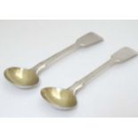 A pair of fiddle pattern salt spoons with gilded bowls.