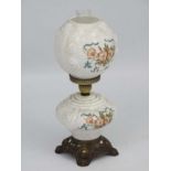 A Victorian style oil lamp with transfer floral style decoration and moulded white glass shade and