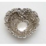 A Victorian silver pin dish of heart form with embossed decoration.