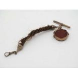 9ct Gold Revolving seal and human hair ropetwist cord : a 9ct gold mounted revolving seal having