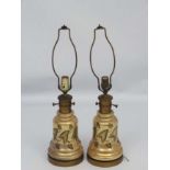 A pair of early 20thC oil lamp conversions now formed as electric table lamps with gilded brass and