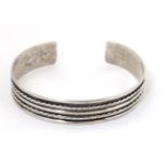 A silver bracelet of bangle form CONDITION: Please Note - we do not make reference