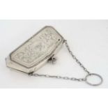 A silver purse with engraved decoration and calf skin lined interior,