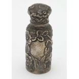 A Victorian silver scent bottle with floral decoration.