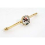 Horse Racing interest: A yellow metal bar brooch set with central Essex Crystal cabochon depicting