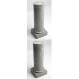 A pair of solid Grey Marble columns of circular form with squared bases,