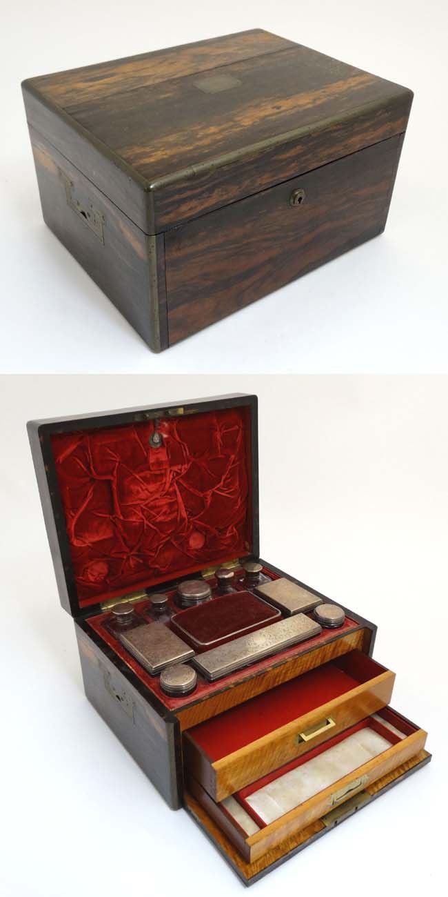 A 19thC ladies Coromandel vanity box opening to reveal a fold down front with satinwood drawers and