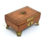 A Regency gold tooled leather covered small sewing box with gilded legs,