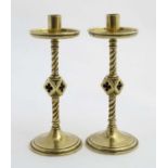 A pair of 19thC Gothic Revival turned brass candlesticks with trefoil and pierced quatrefoil