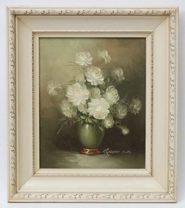 Robert Cox (1934 - 2001), Oil on board, White roses in a vase on a table, Signed lower right.