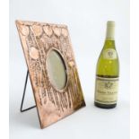 Art Nouveau : A punch work copper frame with poppy decoration and oval glazed centre and easel /