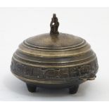 A cast bronze four footed Chinese lidded sensor with banded decoration and 2 handles.