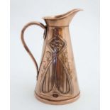 Art Nouveau : A Joseph Sankey & Son embossed copper jug . Signed and marked under 1 1/2".