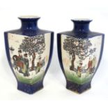 A pair of Oriental vases of square shape decorated in panels with figures in a landscape on a